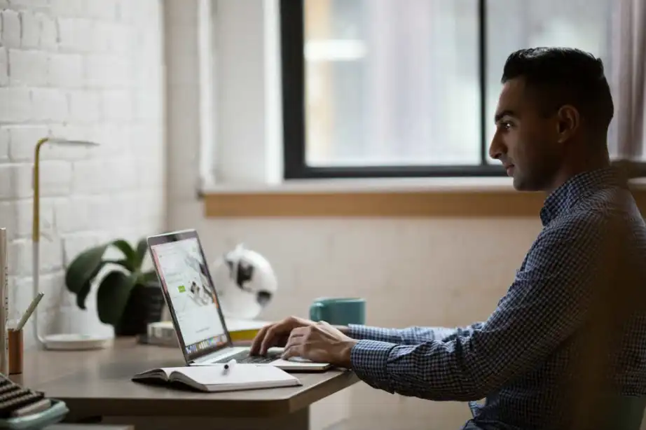 Young man working at a desk on a laptop