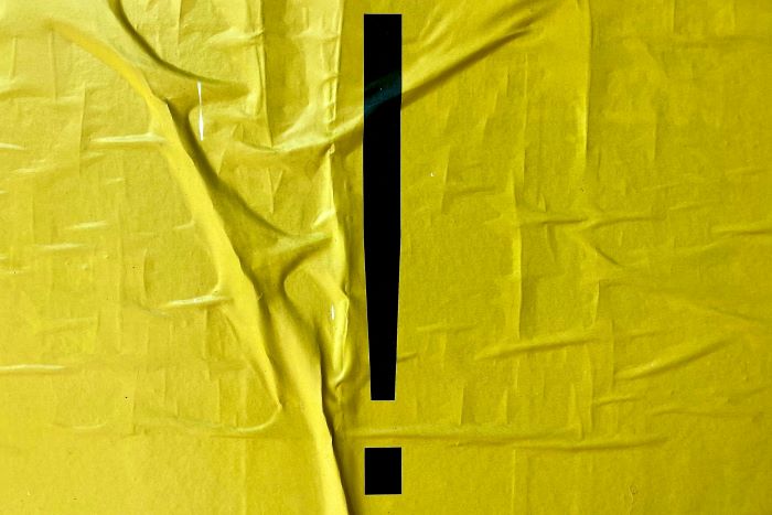 A black exclamation mark on a yellow background