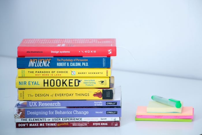 A stack of various books related to the topic of user behavior and user experience 